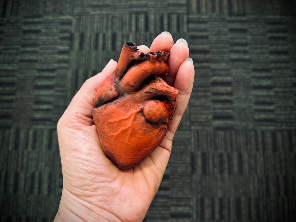 Painted 3D heart held in hand